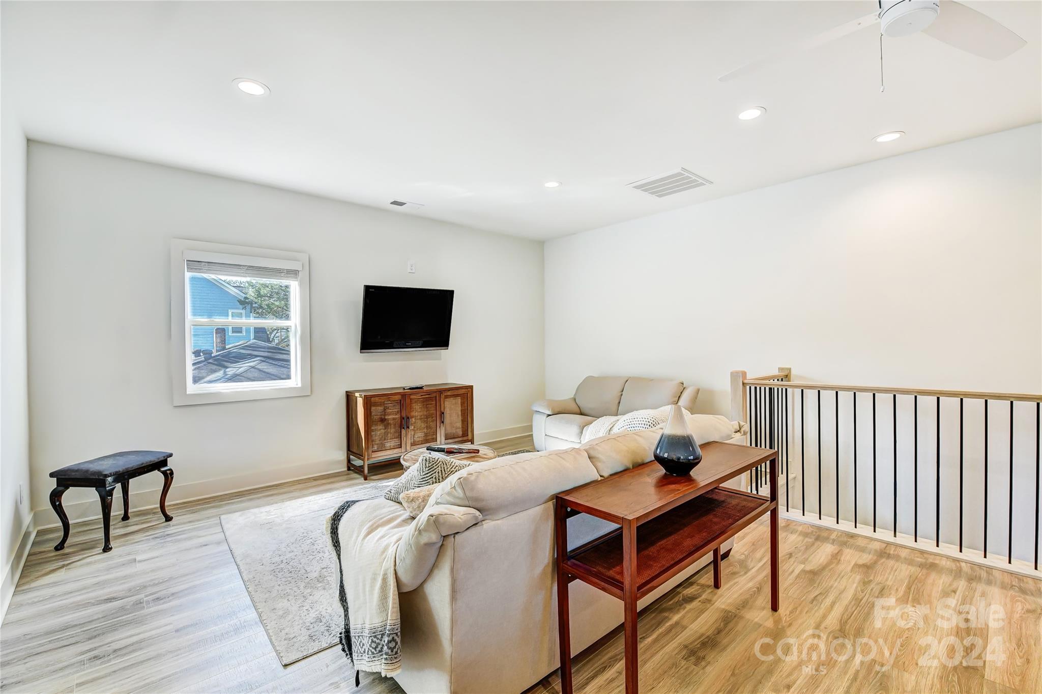 526 Seldon Drive Charlotte, NC 28216 - Photo 29 of 46 a living room with furniture and a flat screen tv