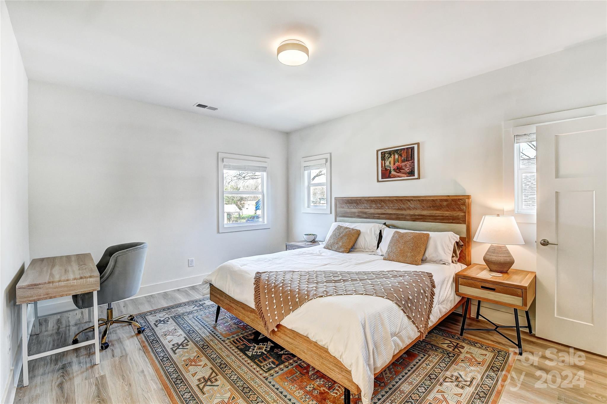 526 Seldon Drive Charlotte, NC 28216 - Photo 30 of 46 a bedroom with a bed and a table in it