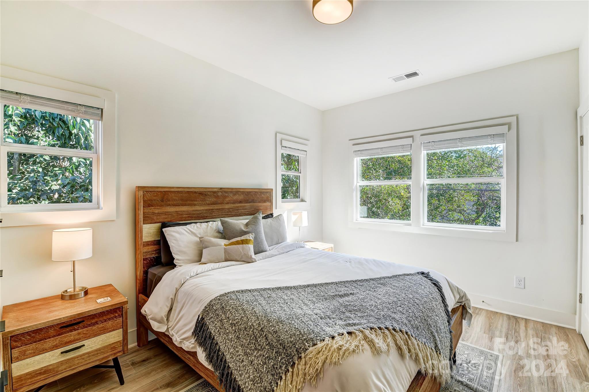 526 Seldon Drive Charlotte, NC 28216 - Photo 35 of 46 a bedroom with a bed and wooden floor