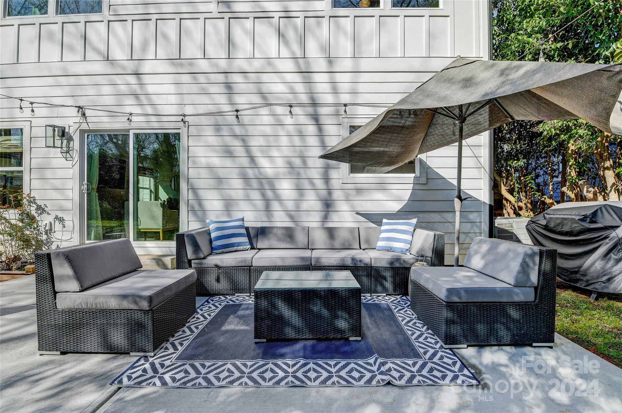 526 Seldon Drive Charlotte, NC 28216 - Photo 41 of 46 a view of a patio with couches table and chairs and potted plants