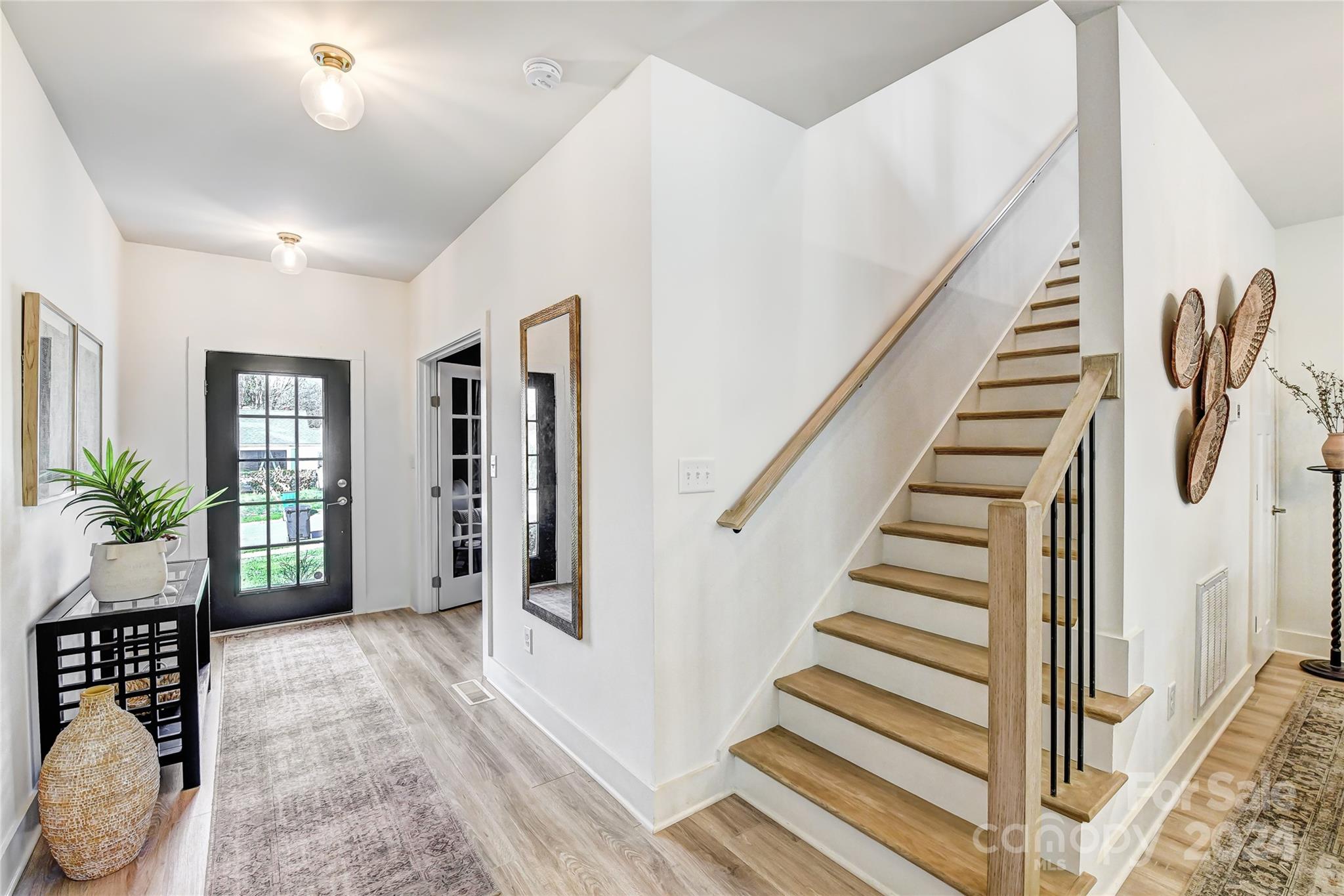 526 Seldon Drive Charlotte, NC 28216 - Photo 5 of 46 a view of entryway with wooden floor and stairs