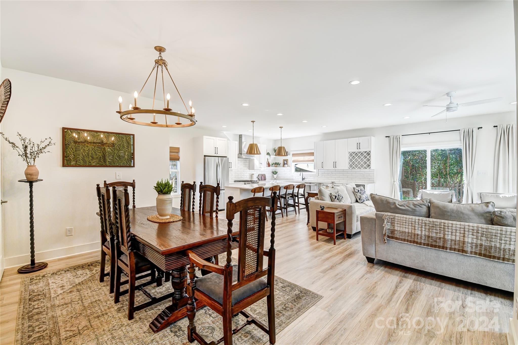 526 Seldon Drive Charlotte, NC 28216 - Photo 7 of 46 a living room with furniture a dining table and a flat screen tv