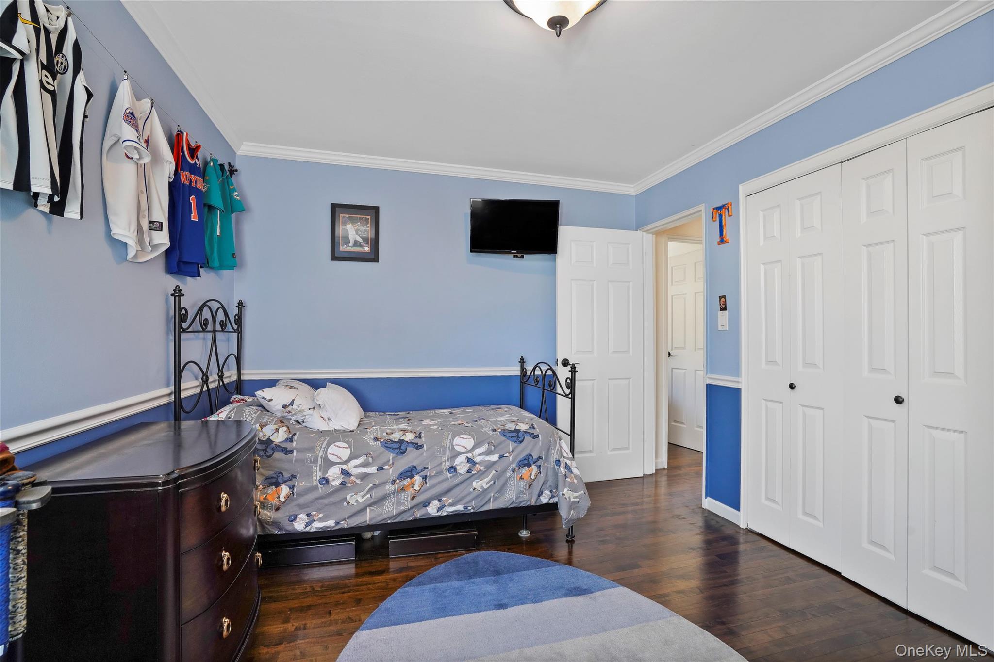 91-03 156th Avenue Queens, NY 11414 - Photo 18 of 50 Bedroom featuring ornamental molding, dark wood-type flooring, and a closet