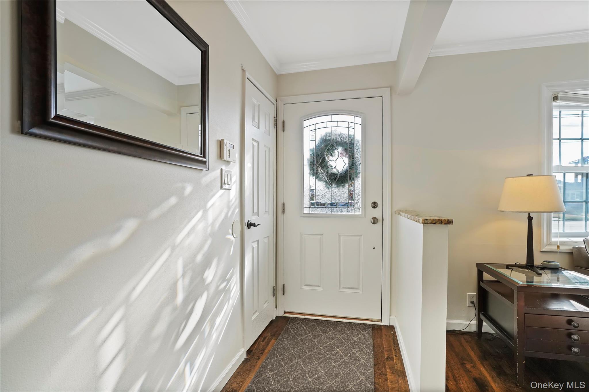 91-03 156th Avenue Queens, NY 11414 - Photo 2 of 50 Entryway with dark wood-type flooring, ornamental molding, and beam ceiling