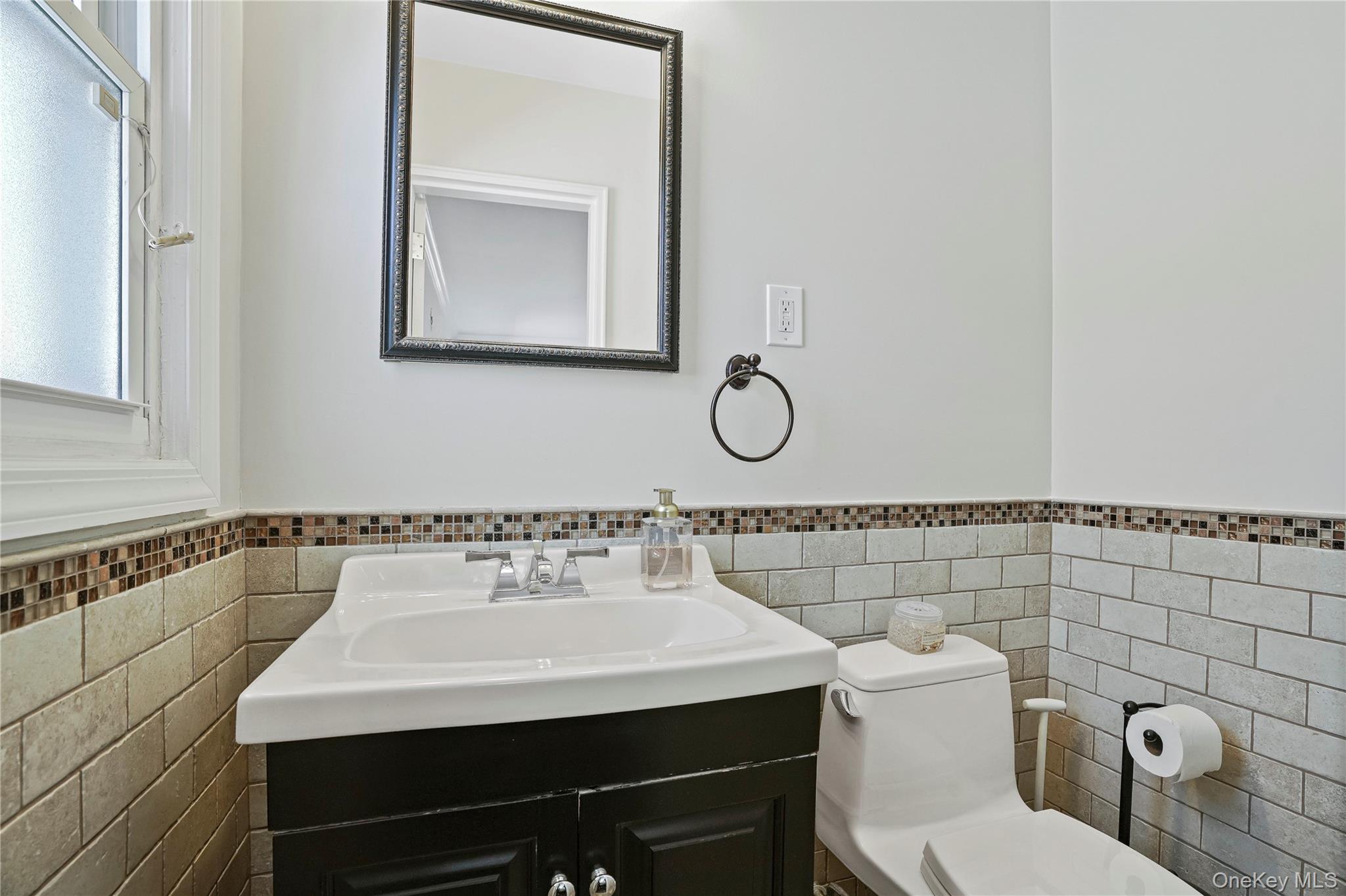 91-03 156th Avenue Queens, NY 11414 - Photo 26 of 50 Bathroom with tile walls, vanity, and a wainscoted wall