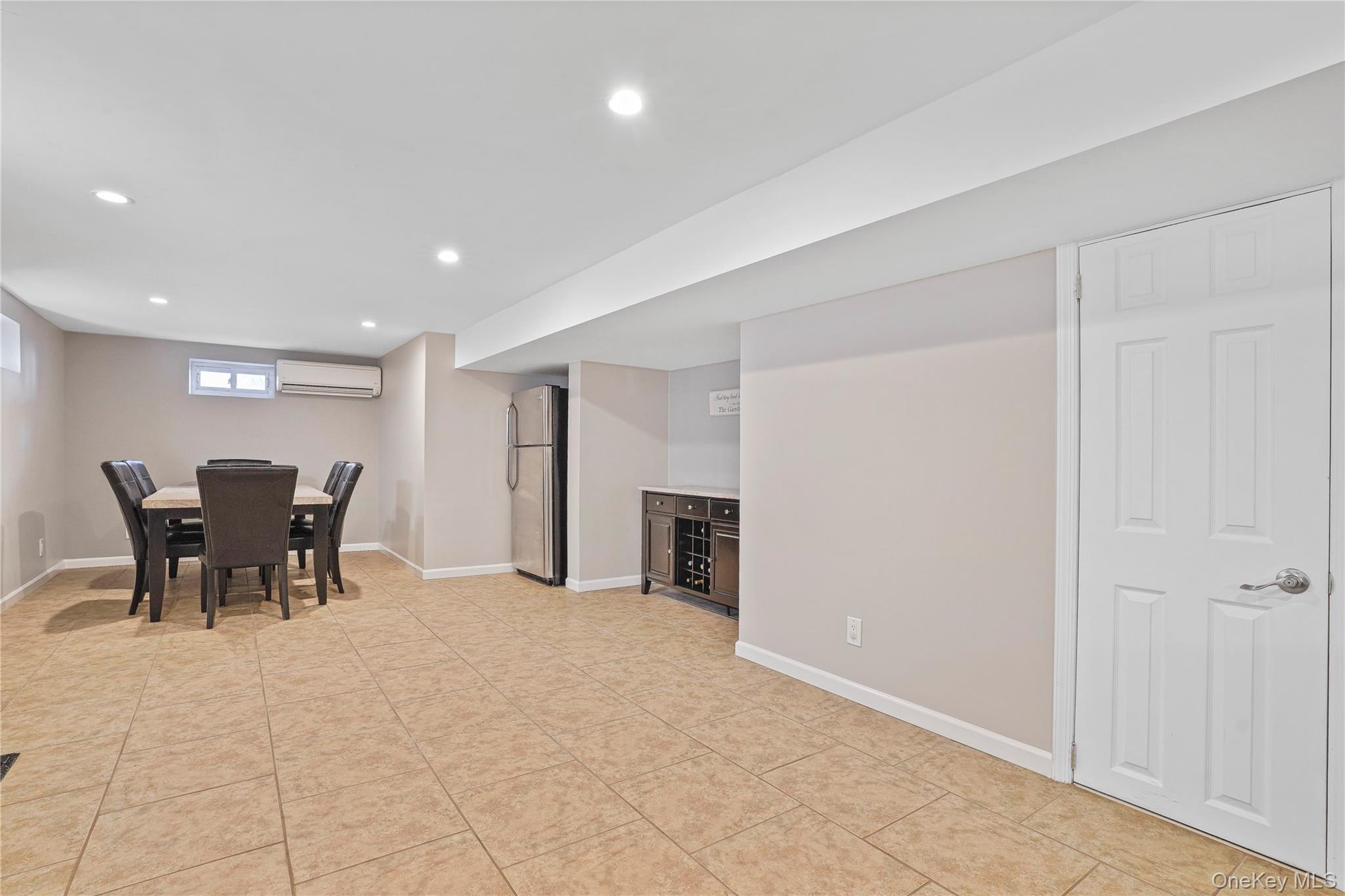 91-03 156th Avenue Queens, NY 11414 - Photo 30 of 50 Dining room with recessed lighting, a wall mounted AC, and light tile patterned floors