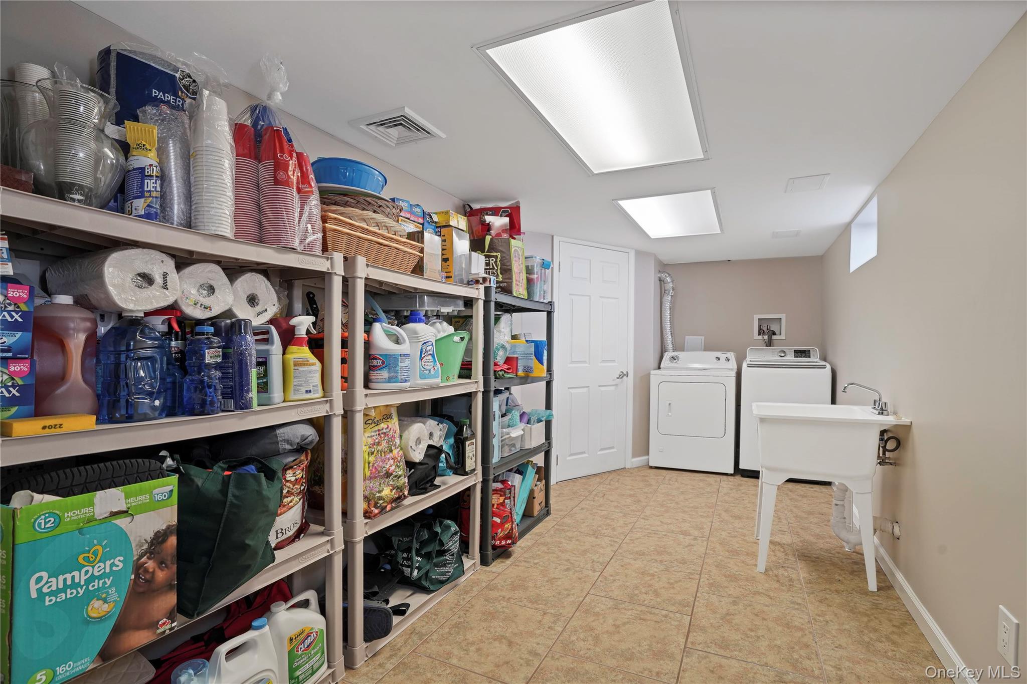 91-03 156th Avenue Queens, NY 11414 - Photo 36 of 50 Laundry room with separate washer and dryer and light tile patterned flooring