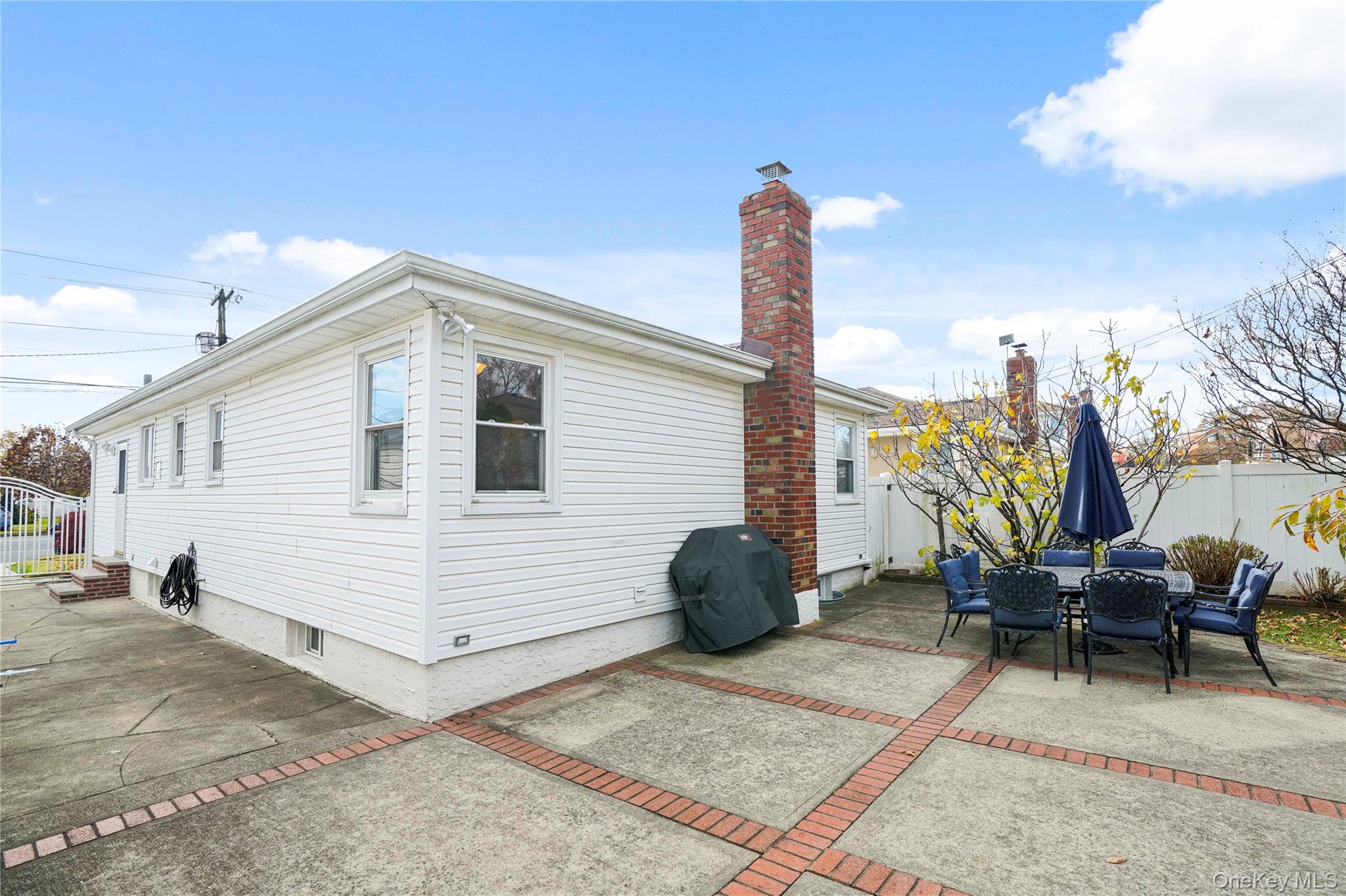 91-03 156th Avenue Queens, NY 11414 - Photo 44 of 50 View of home's exterior featuring a chimney, a patio area, and outdoor dining space