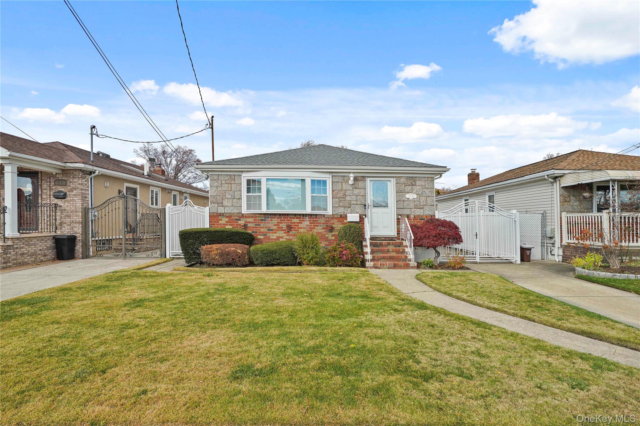 91-03 156th Avenue Queens, NY 11414 - Photo 48 of 50 View of front of property with a gate, stone siding, a shingled roof, and brick siding