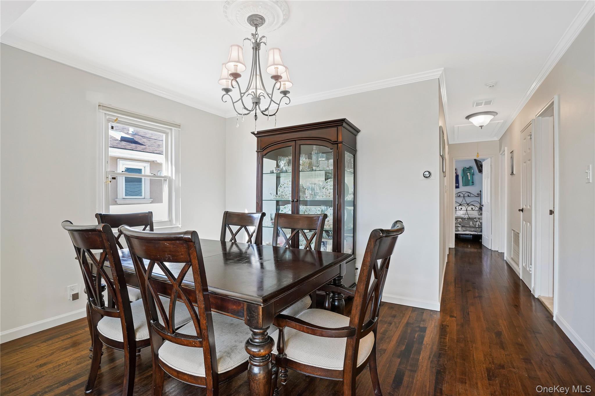 91-03 156th Avenue Queens, NY 11414 - Photo 8 of 50 Dining space with crown molding, dark wood finished floors, and a chandelier