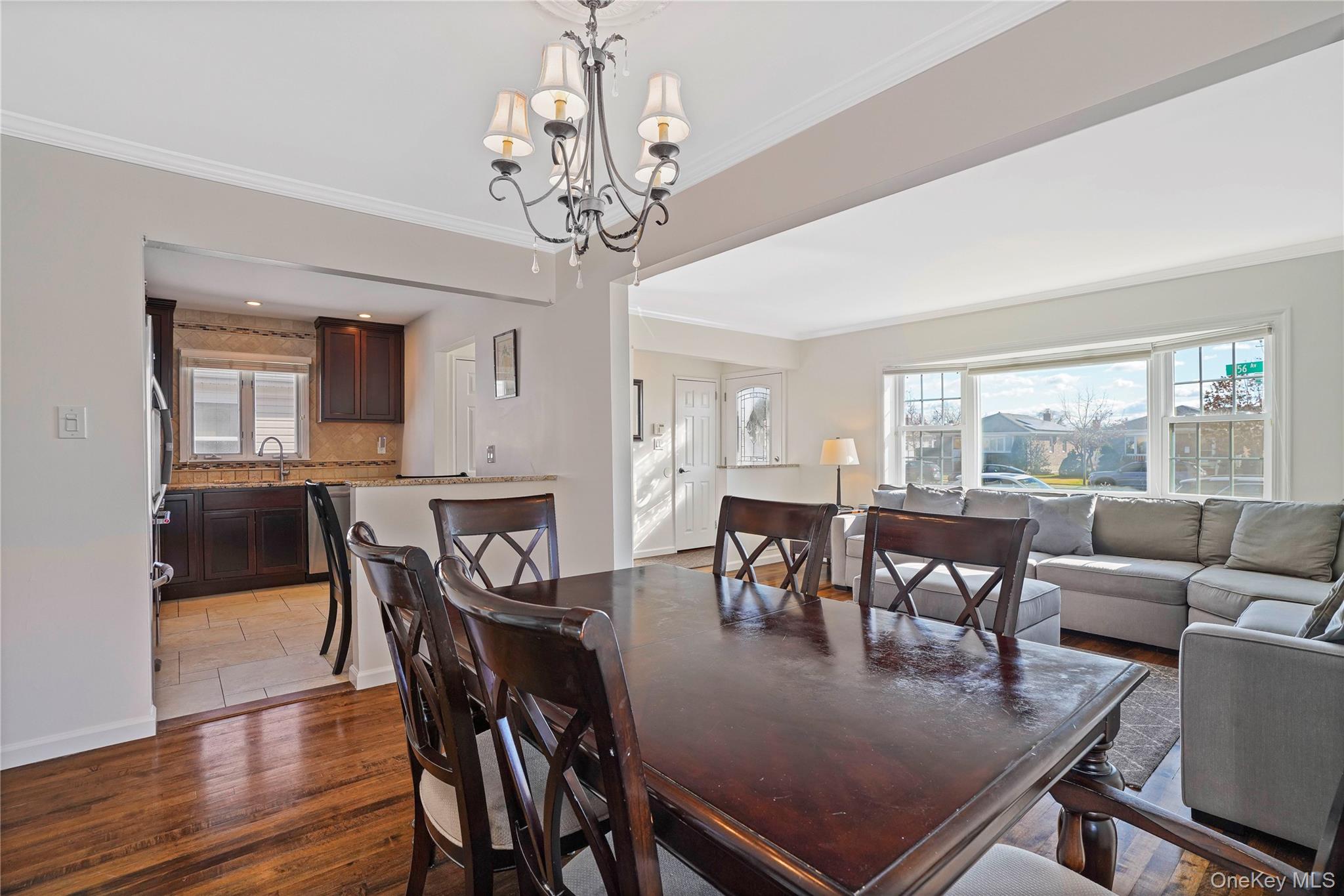91-03 156th Avenue Queens, NY 11414 - Photo 10 of 50 Dining area with dark wood-style flooring, crown molding, and a chandelier