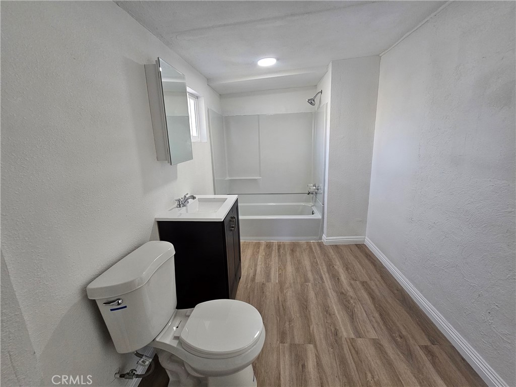 207-207 East O Street Colton, CA 92324 - Photo 13 of 26 a bathroom with a sink toilet and mirror