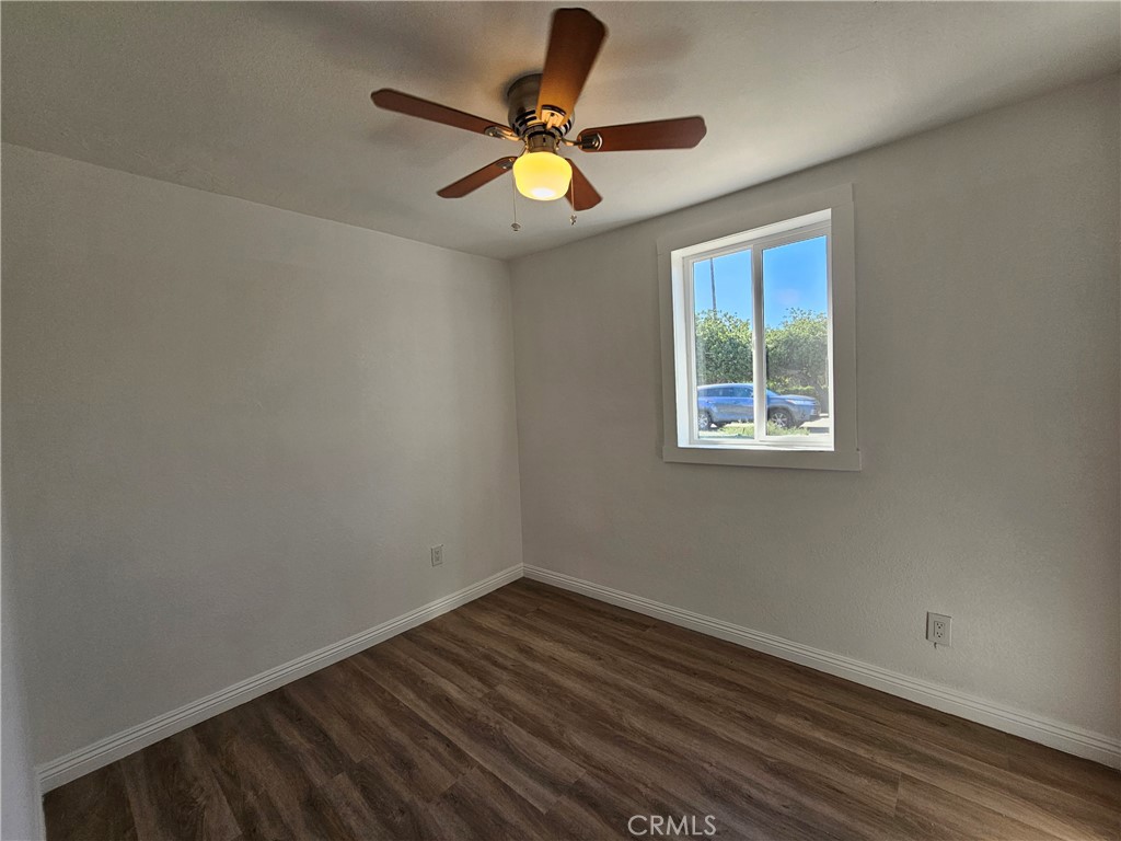 207-207 East O Street Colton, CA 92324 - Photo 14 of 26 a view of room with window ceiling fan and hardwood floor