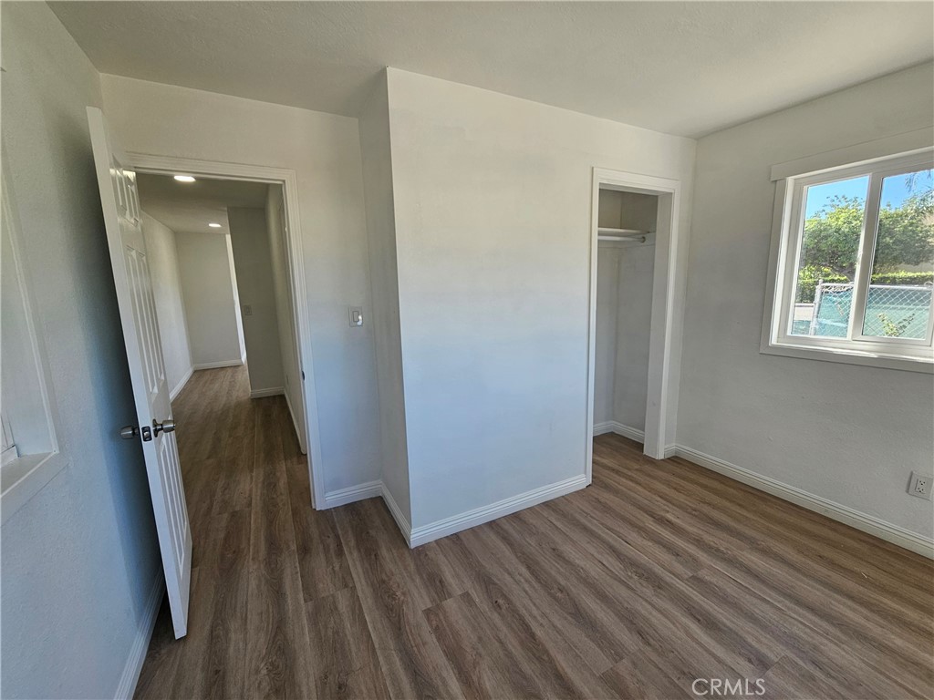 207-207 East O Street Colton, CA 92324 - Photo 17 of 26 an empty room with wooden floor and windows