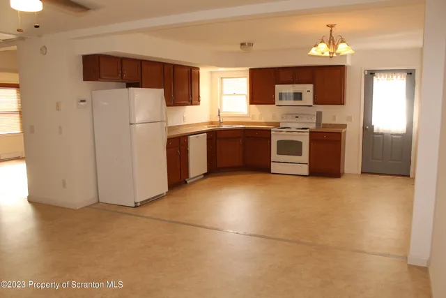 a kitchen with stainless steel appliances a refrigerator sink and microwave
