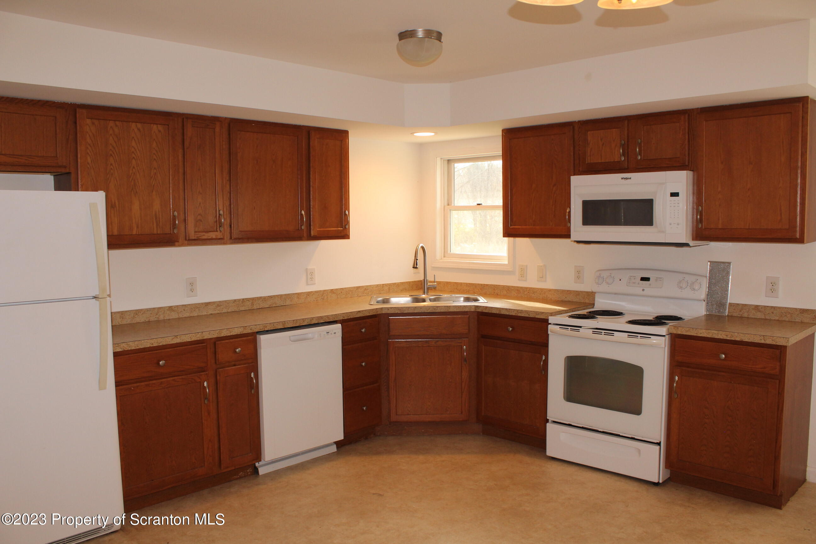 23 Delany Drive Tunkhannock, PA 18657 - Photo 4 of 8 a kitchen with stainless steel appliances granite countertop a stove a sink and a microwave