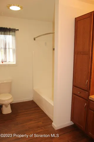 a bathroom with a toilet a sink and a shower