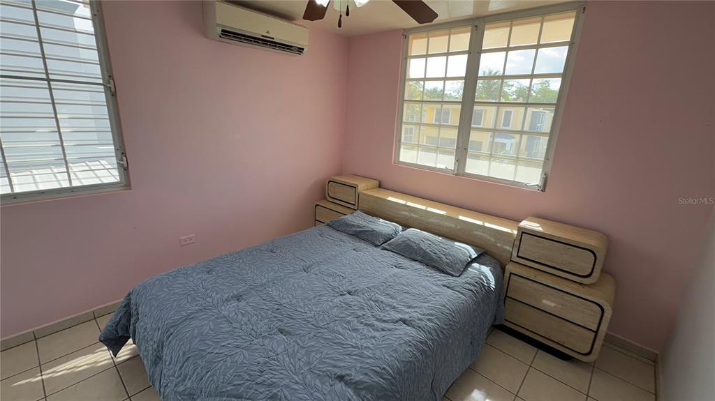 1 St Rio Grande, Unit B6 Rio Grande, PR 00745 - Photo 44 of 47 a bedroom with a bed and a chandelier