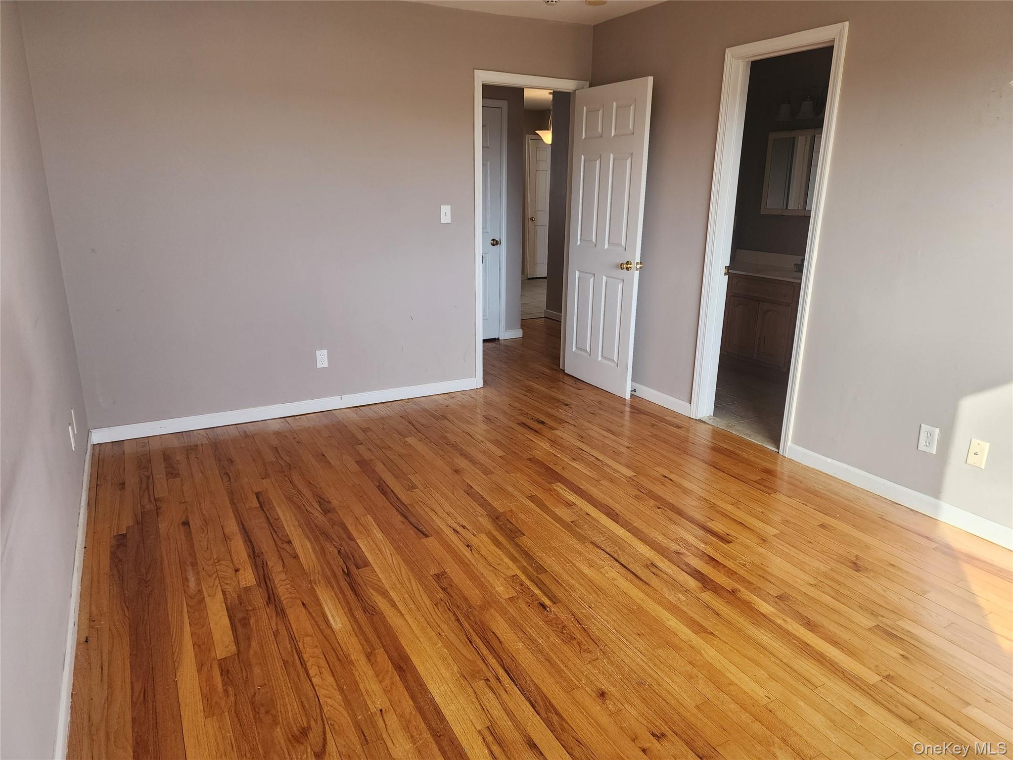 18 Pavilion Ridge Way, Unit 1 Suffern, NY 10901 - Photo 9 of 15 a view of an empty room with wooden floor and a bathroom