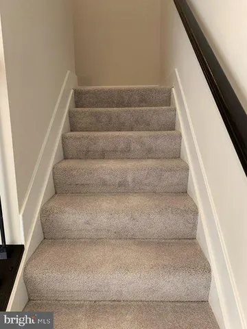 a view of staircase with white walls