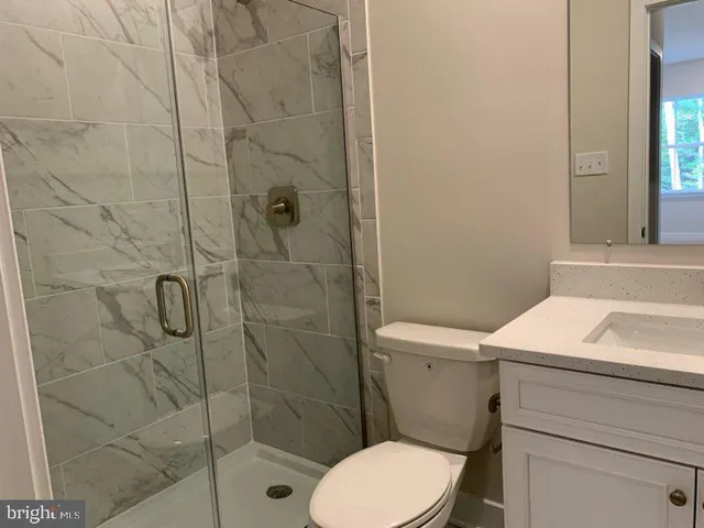 a bathroom with a toilet a sink and shower