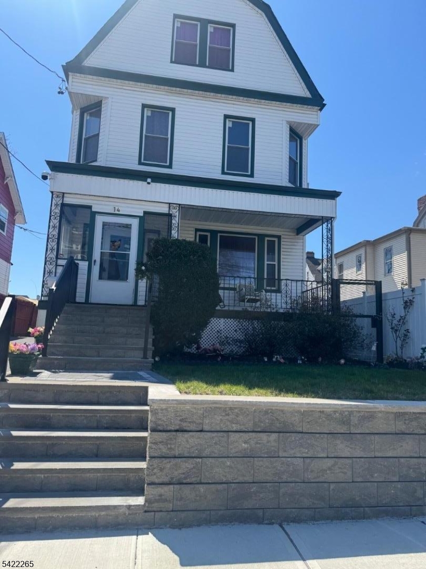 a view of a house with a small yard and a large window