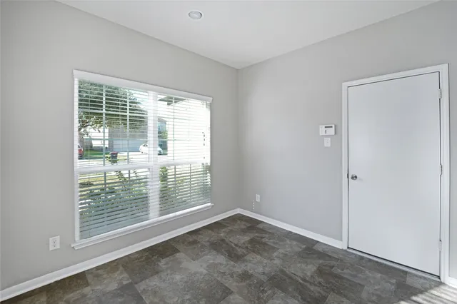 a view of empty room with floor to ceiling window