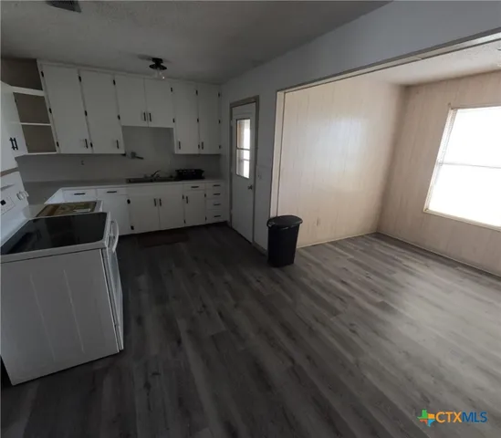 a kitchen with a sink and cabinets