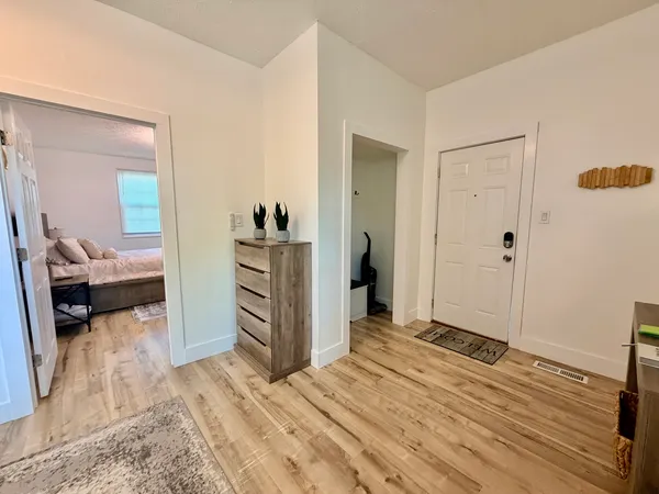 a view of a bedroom with wooden floor