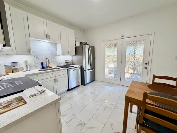 a kitchen with stainless steel appliances granite countertop a sink stove and refrigerator