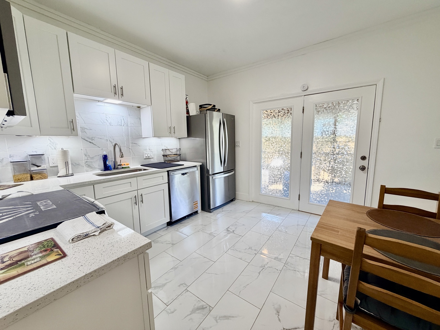 1112 Ophia Street Metropolis, IL 62960 - Photo 13 of 32 a kitchen with stainless steel appliances granite countertop a sink stove and refrigerator