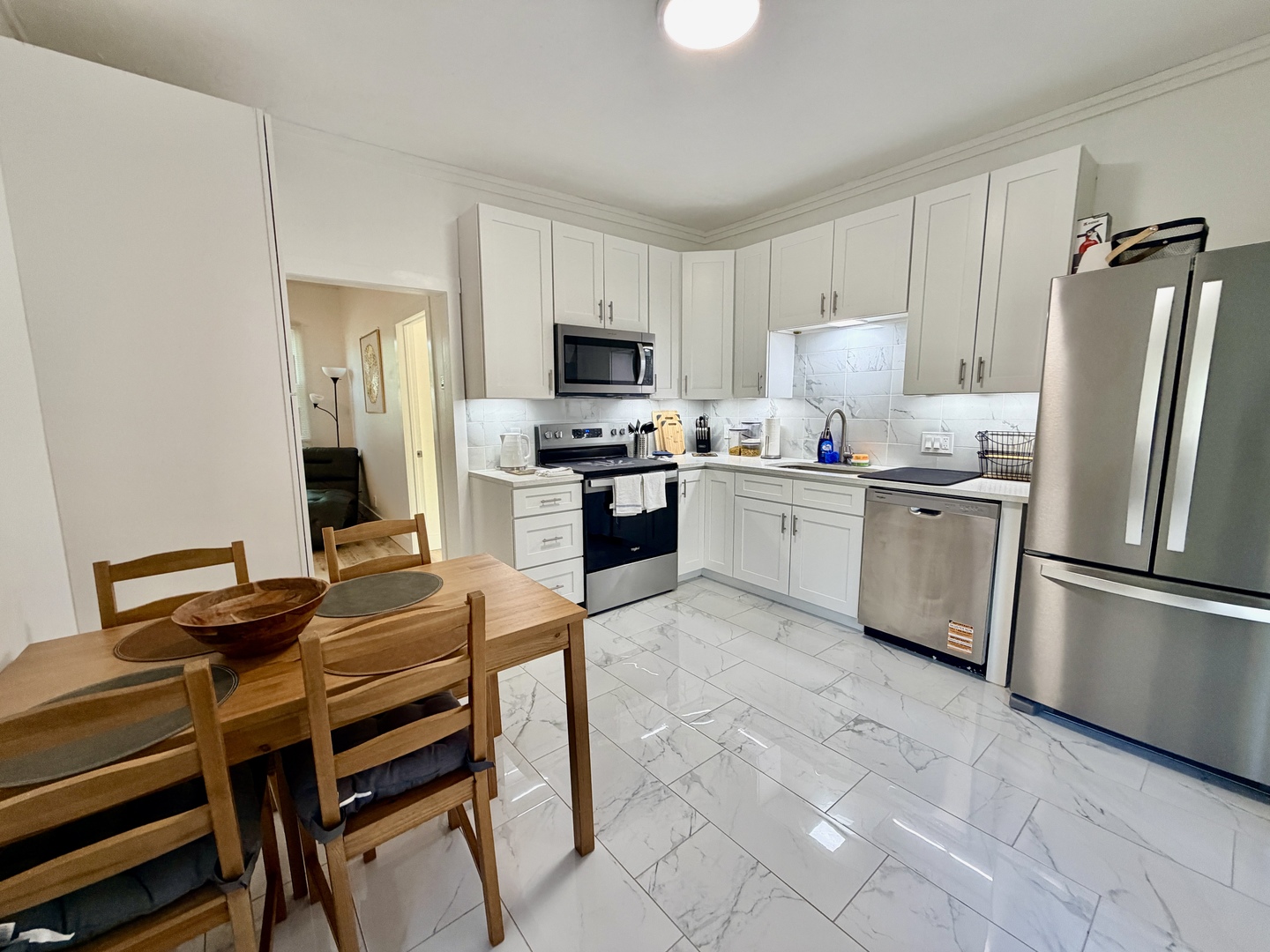 1112 Ophia Street Metropolis, IL 62960 - Photo 15 of 32 a kitchen with stainless steel appliances a stove a sink refrigerator and a table