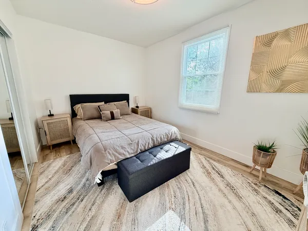 a bedroom with a bed and a window