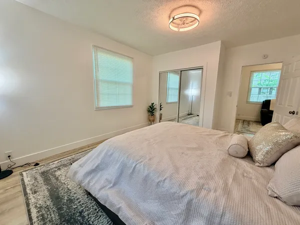 a bedroom with a bed and a window