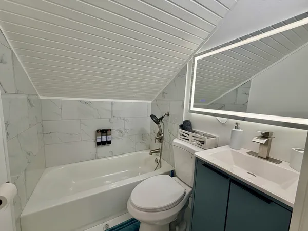 a bathroom with a sink a toilet and bathtub