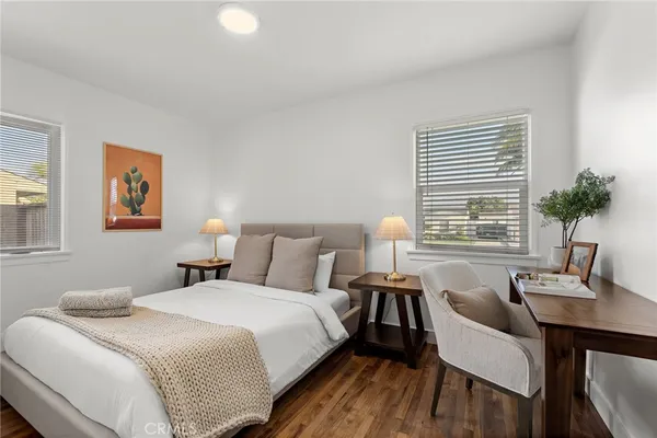 a bedroom with a bed and a table with chair