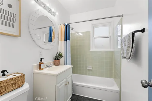 a bathroom with a sink vanity mirror and shower