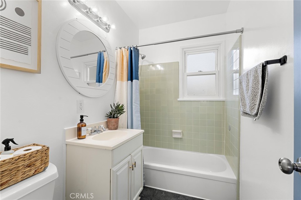 5027 West 135th Street Hawthorne, CA 90250 - Photo 13 of 24 a bathroom with a sink vanity mirror and shower