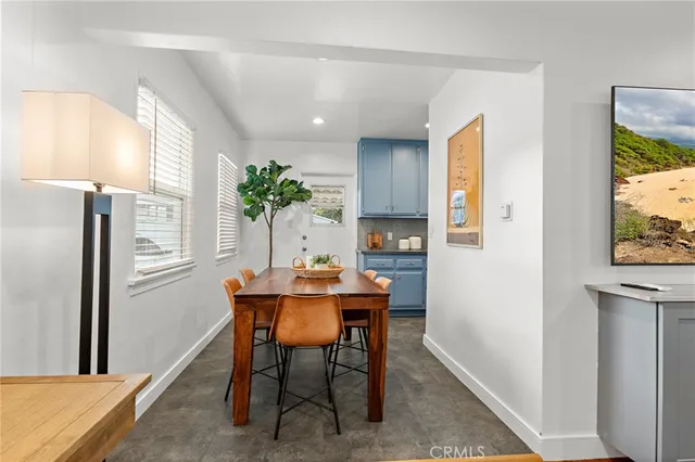 a view of a dining room with furniture and a window