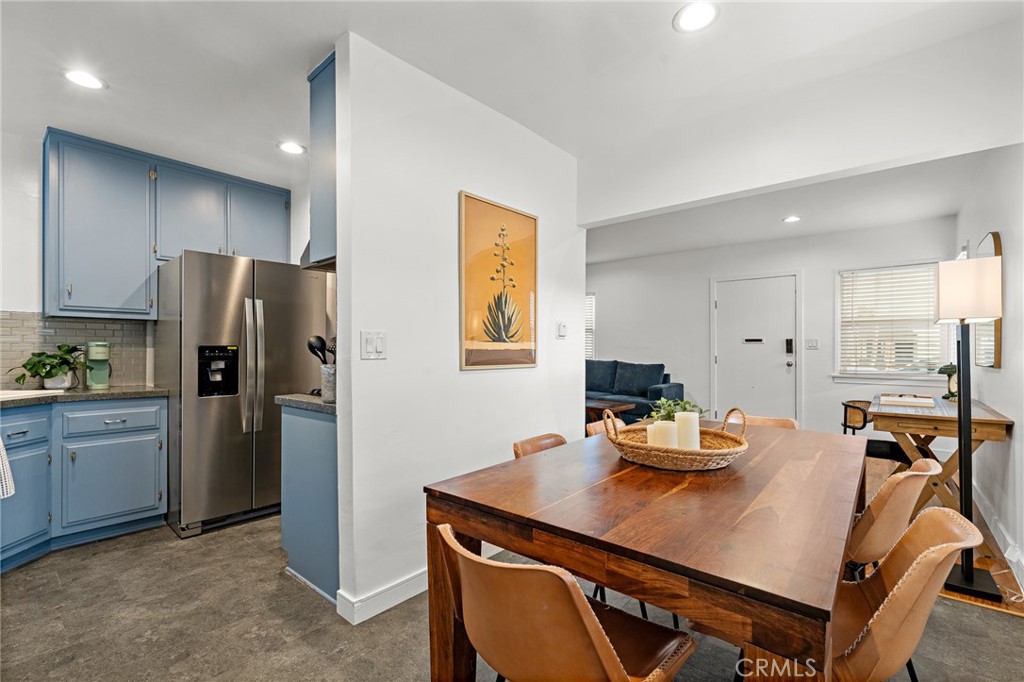 5027 West 135th Street Hawthorne, CA 90250 - Photo 7 of 24 a room with a refrigerator a stove a sink dishwasher with a dining table and chairs