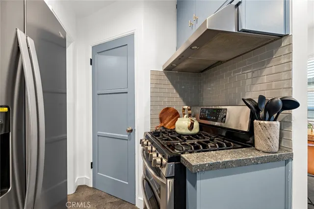 a kitchen with a stove and a refrigerator