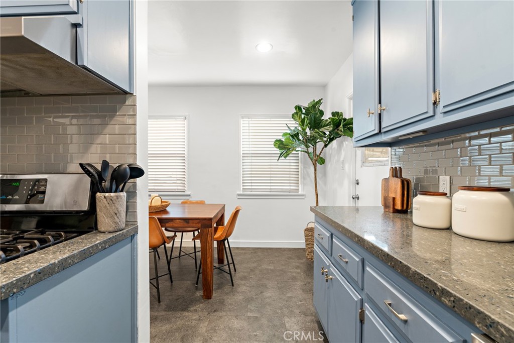 5027 West 135th Street Hawthorne, CA 90250 - Photo 10 of 24 a kitchen with stainless steel appliances granite countertop sink stove top oven and cabinets
