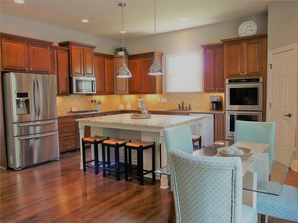 3970 Sweeting Street Cumming, GA 30041 - Photo 11 of 17 a kitchen with stainless steel appliances granite countertop a refrigerator a stove top oven a sink and dishwasher
