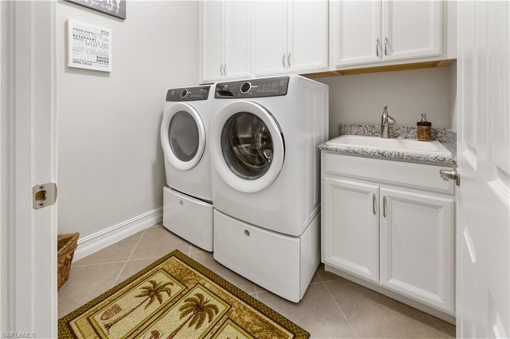 14671 Topsail Drive Naples, FL 34114 - Photo 14 of 26 a utility room with dryer and washer