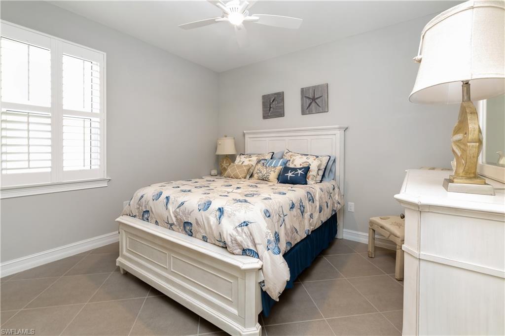 14671 Topsail Drive Naples, FL 34114 - Photo 15 of 26 a bed sitting in a bedroom next to a window