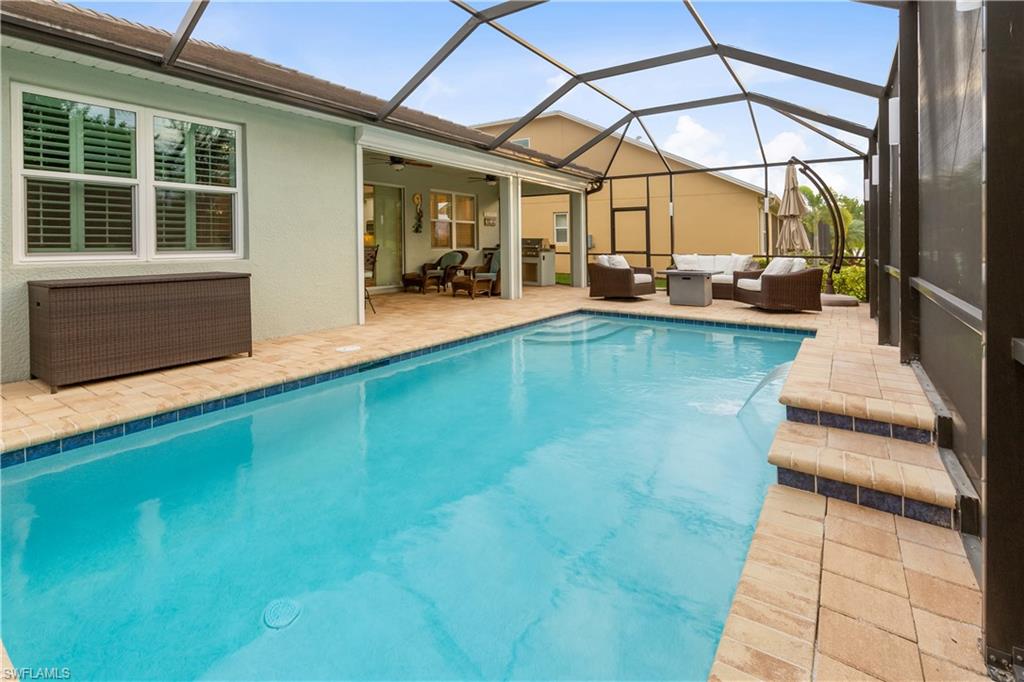 14671 Topsail Drive Naples, FL 34114 - Photo 18 of 26 a view of swimming pool with outdoor seating