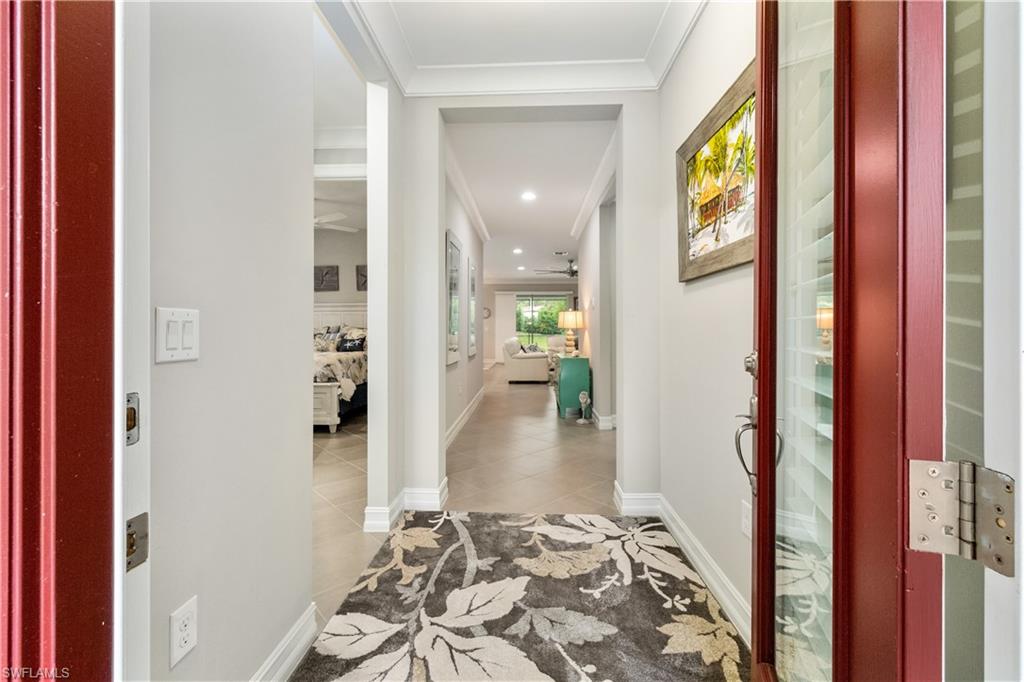 14671 Topsail Drive Naples, FL 34114 - Photo 2 of 26 a view of a hallway with furniture and floor to ceiling window