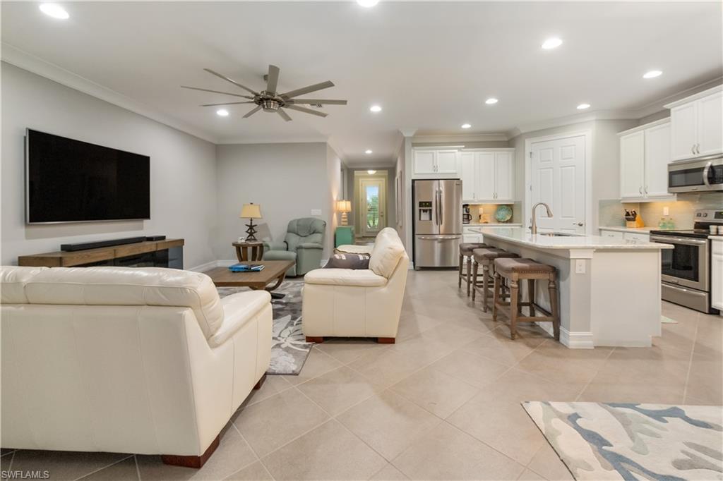 14671 Topsail Drive Naples, FL 34114 - Photo 3 of 26 a living room with furniture and a flat screen tv