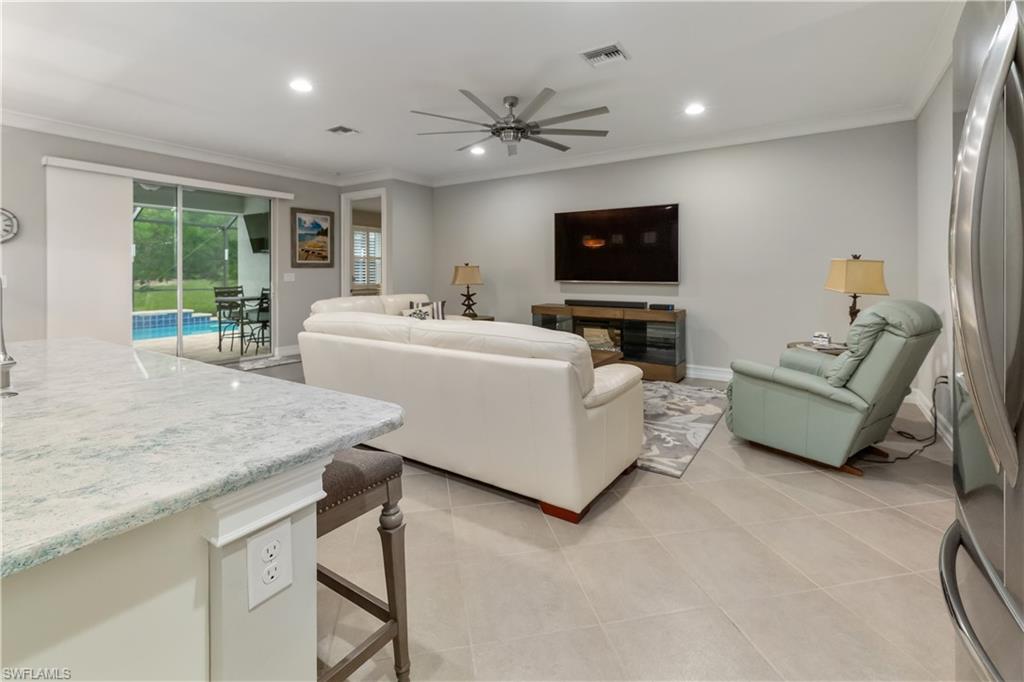 14671 Topsail Drive Naples, FL 34114 - Photo 4 of 26 a living room with furniture and a flat screen tv