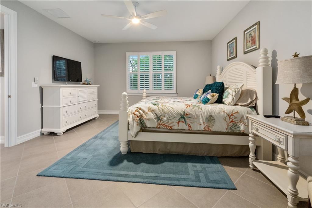 14671 Topsail Drive Naples, FL 34114 - Photo 7 of 26 a bedroom with a bed and flat screen tv